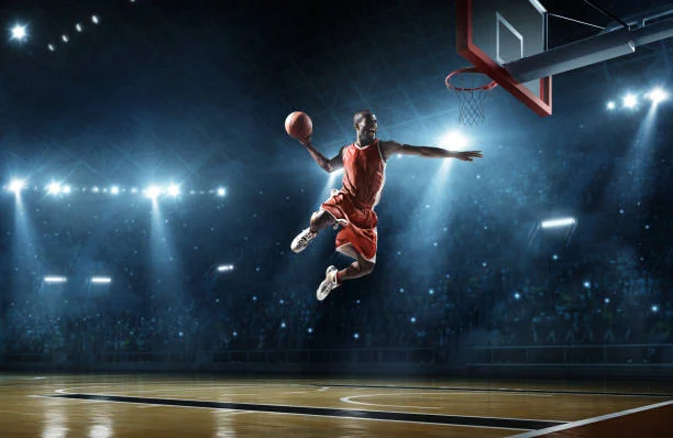 Basketball player dunking in arena